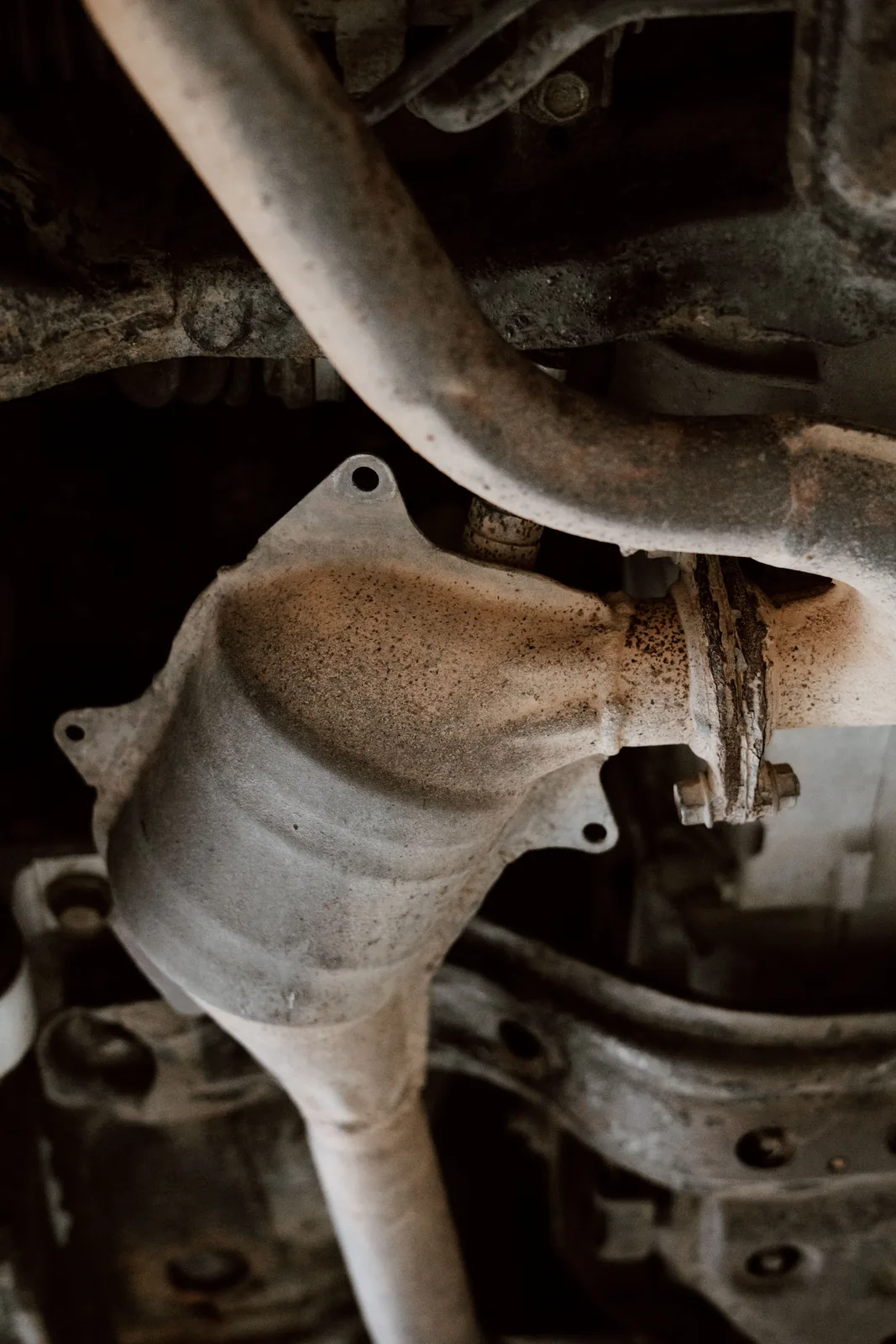 Used catalytic converter and exhaust pipe under a vehicle chassis